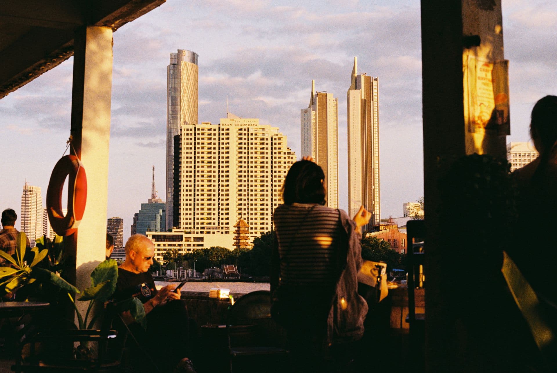 People chilling on the bank of Chao Phraya River in Bangkok Thailand 35mm film photography