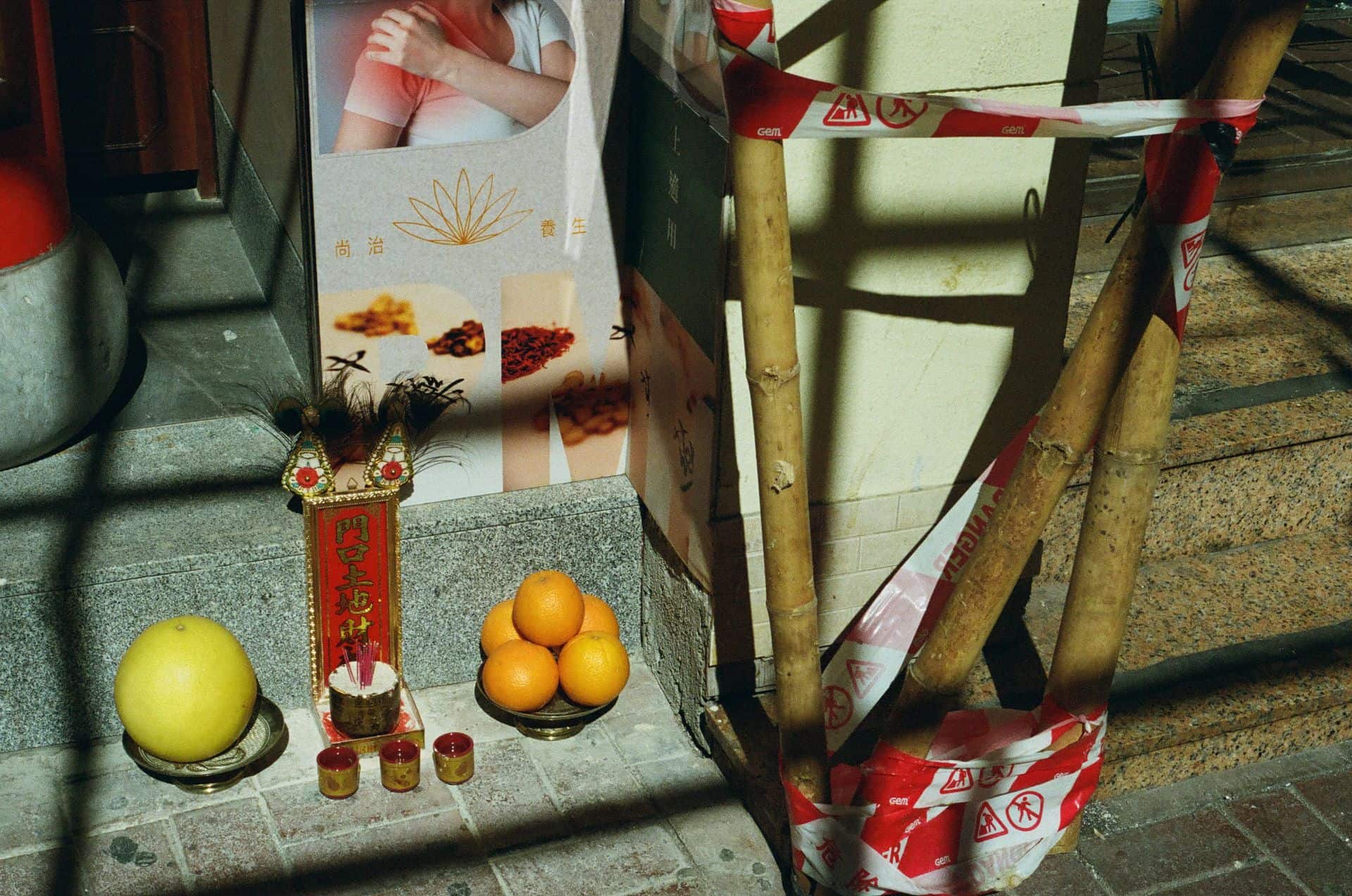 Earth god offerings on the pavement in Hong Kong 35mm film photography