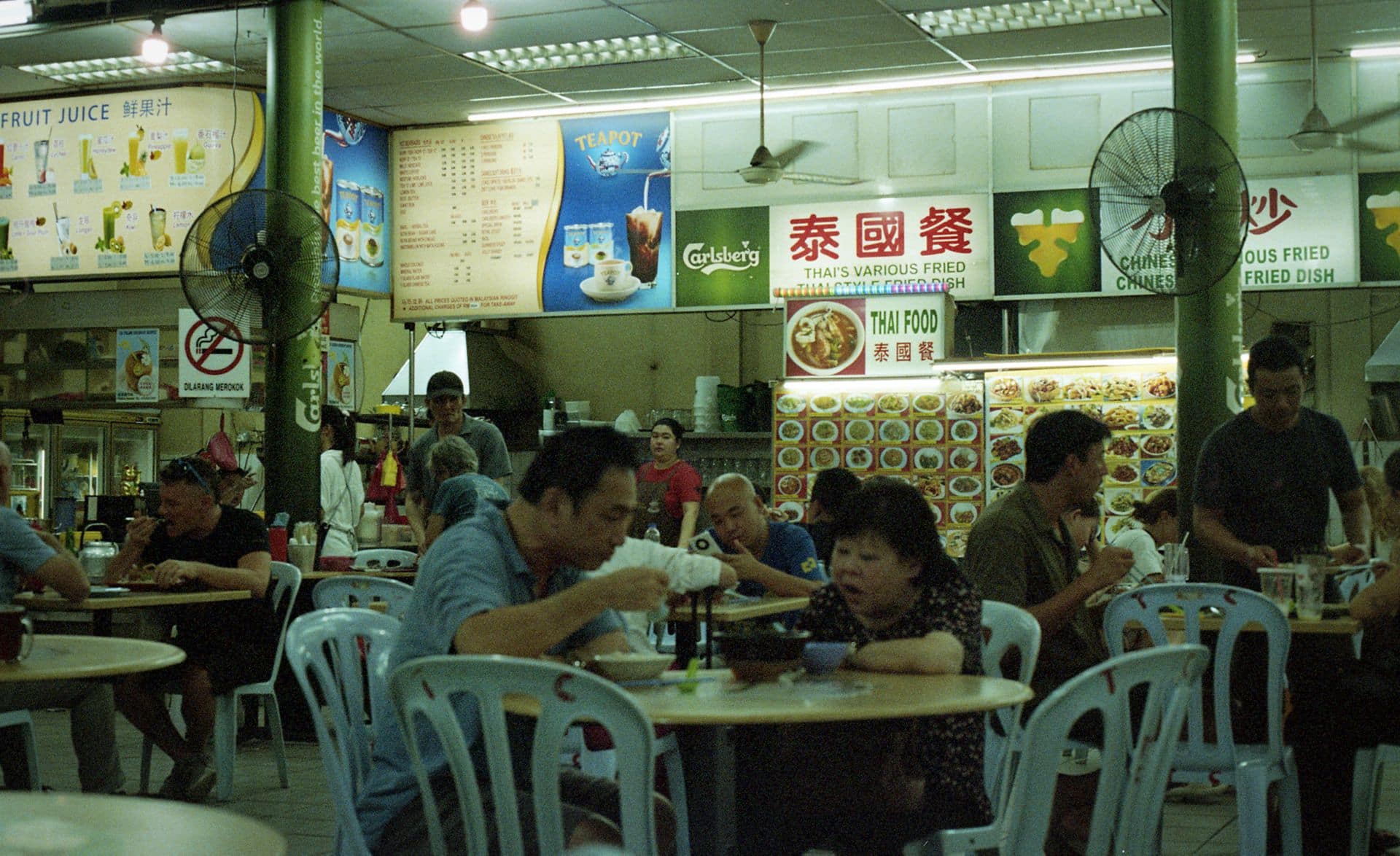 A couple having a dinner at Jalan Alor Food Market in Kuala Lumpur Malaysia 35mm film photography