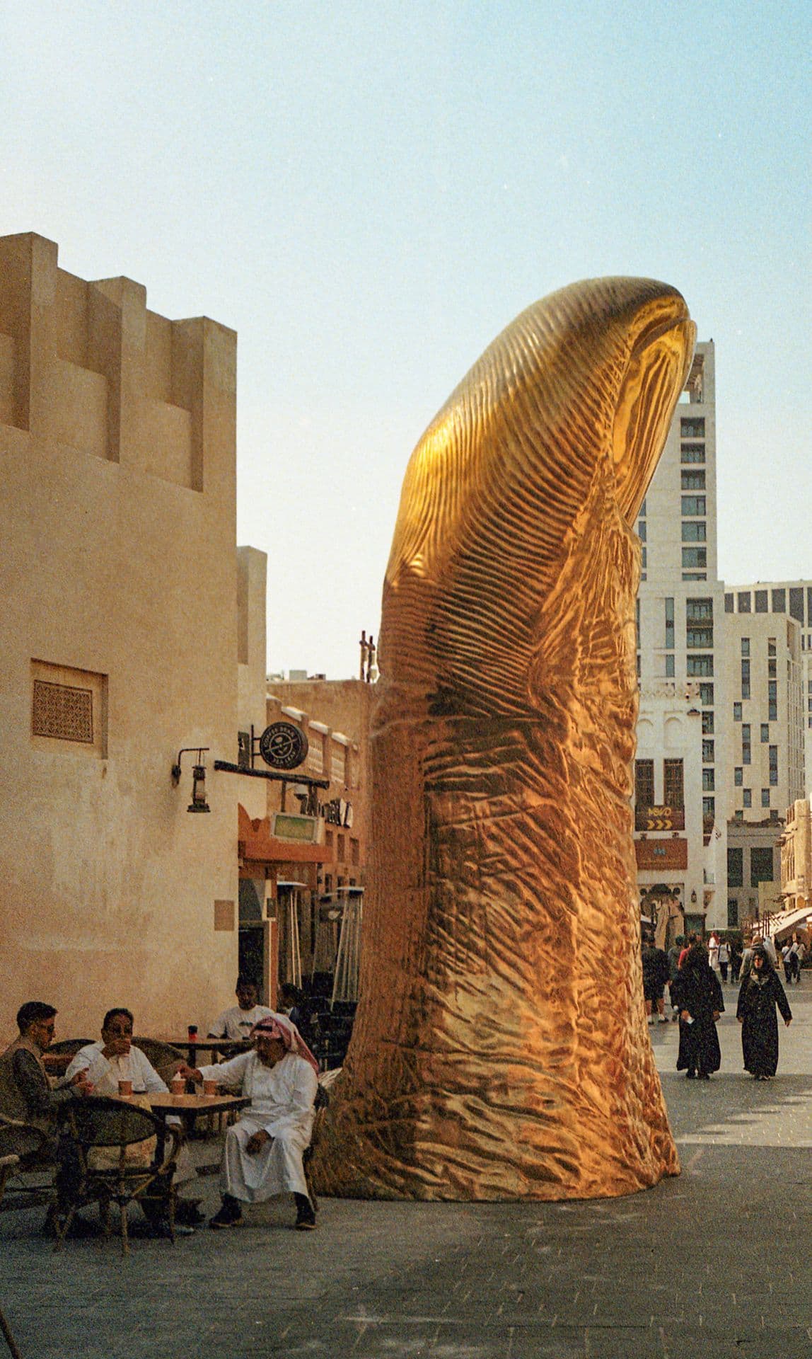 Tea time by a giant thumb sculpture in Doha Qatar 35mm film photography