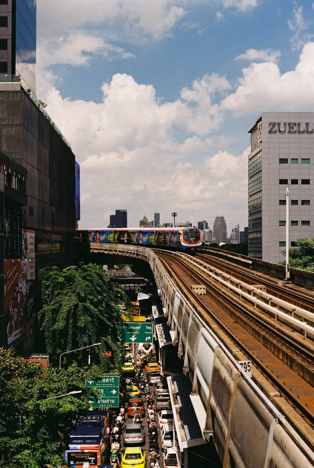 Skytrain arriving on a sunny day above a congestion in Bangkok Thailand 35mm film photography